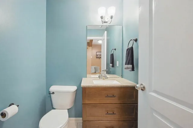 a bathroom with a sink toilet and mirror