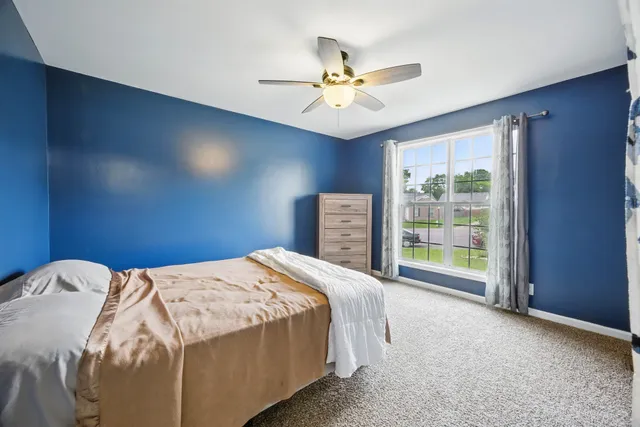a bed sitting in a bedroom next to a window