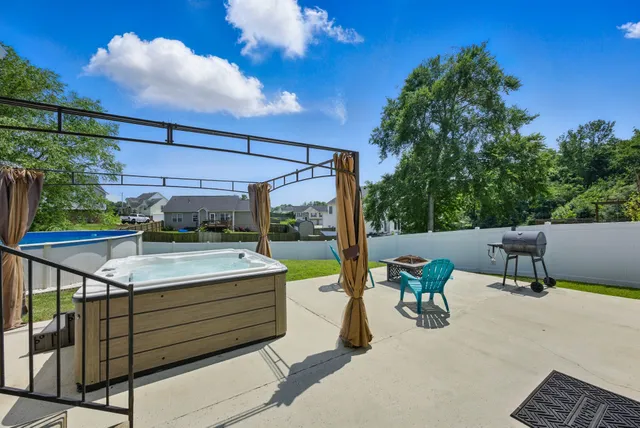 a view of a patio with a table and chairs under an umbrella