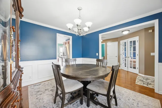 a view of a dining room with furniture and a chandelier