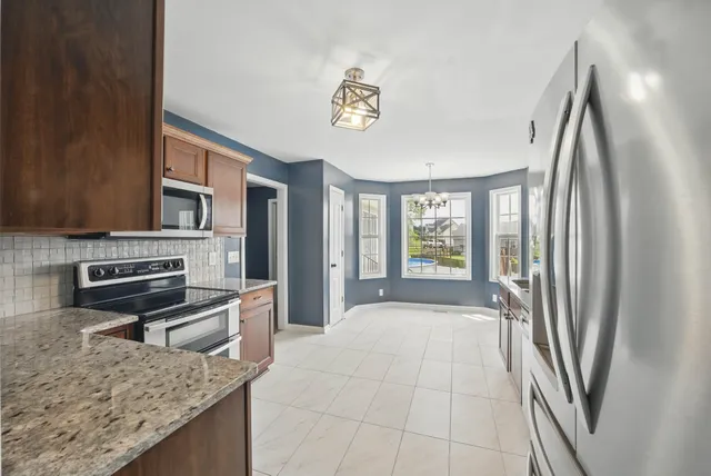 a large kitchen with a stove a refrigerator and a stove
