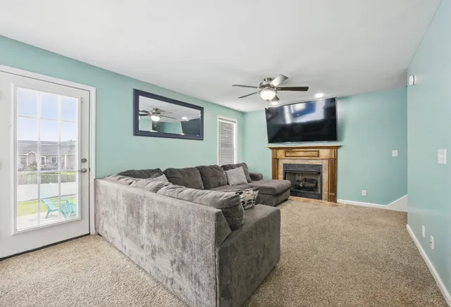 a living room with furniture a fireplace and a flat screen tv