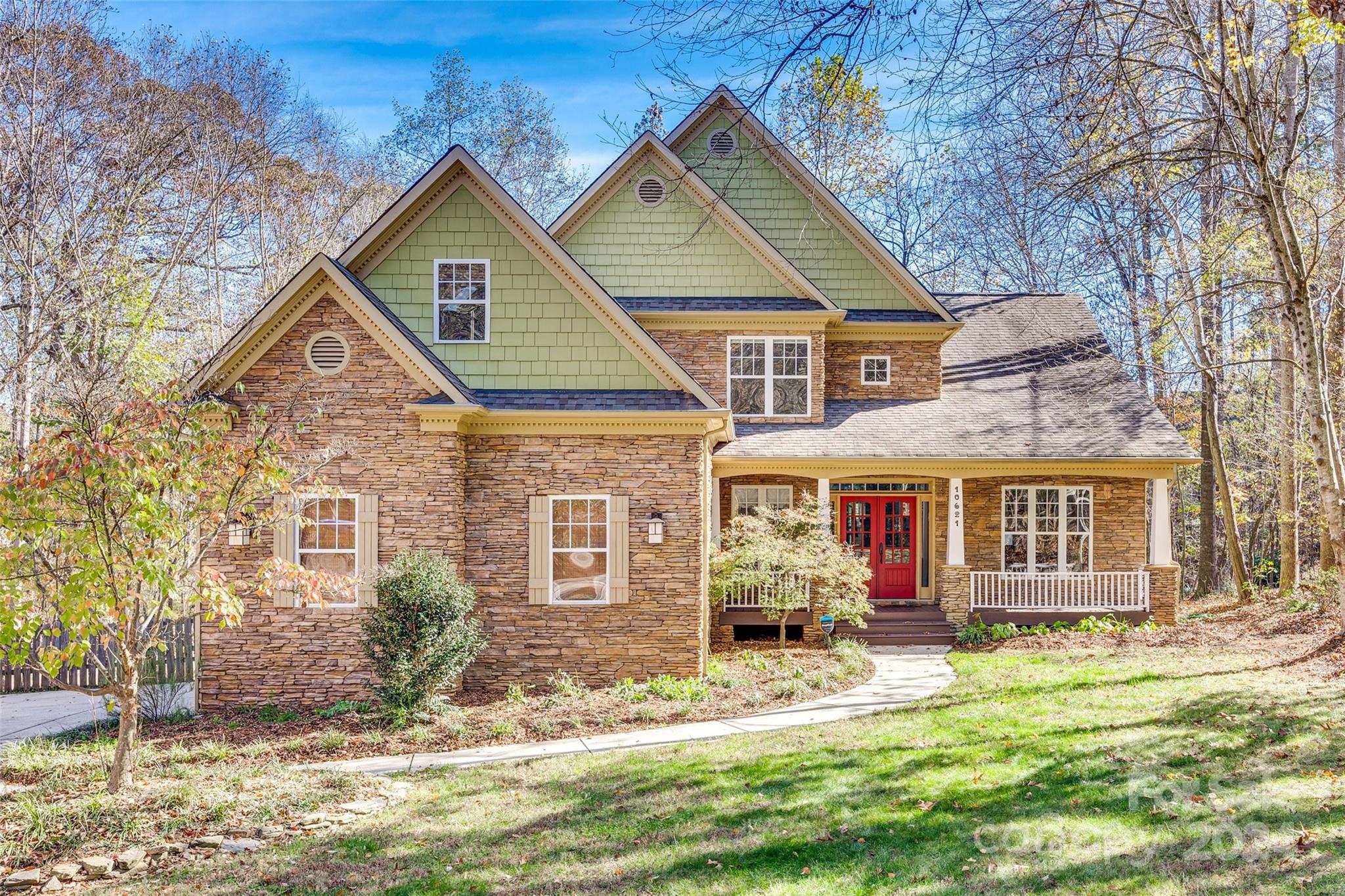a view of a house with a yard patio and fire pit