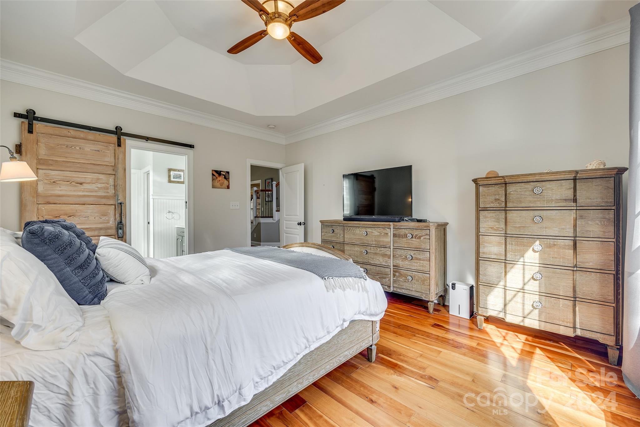 10621 Hanging Moss Trail Charlotte, NC 28227 - Photo 18 of 47 a bedroom with a bed and a flat screen tv