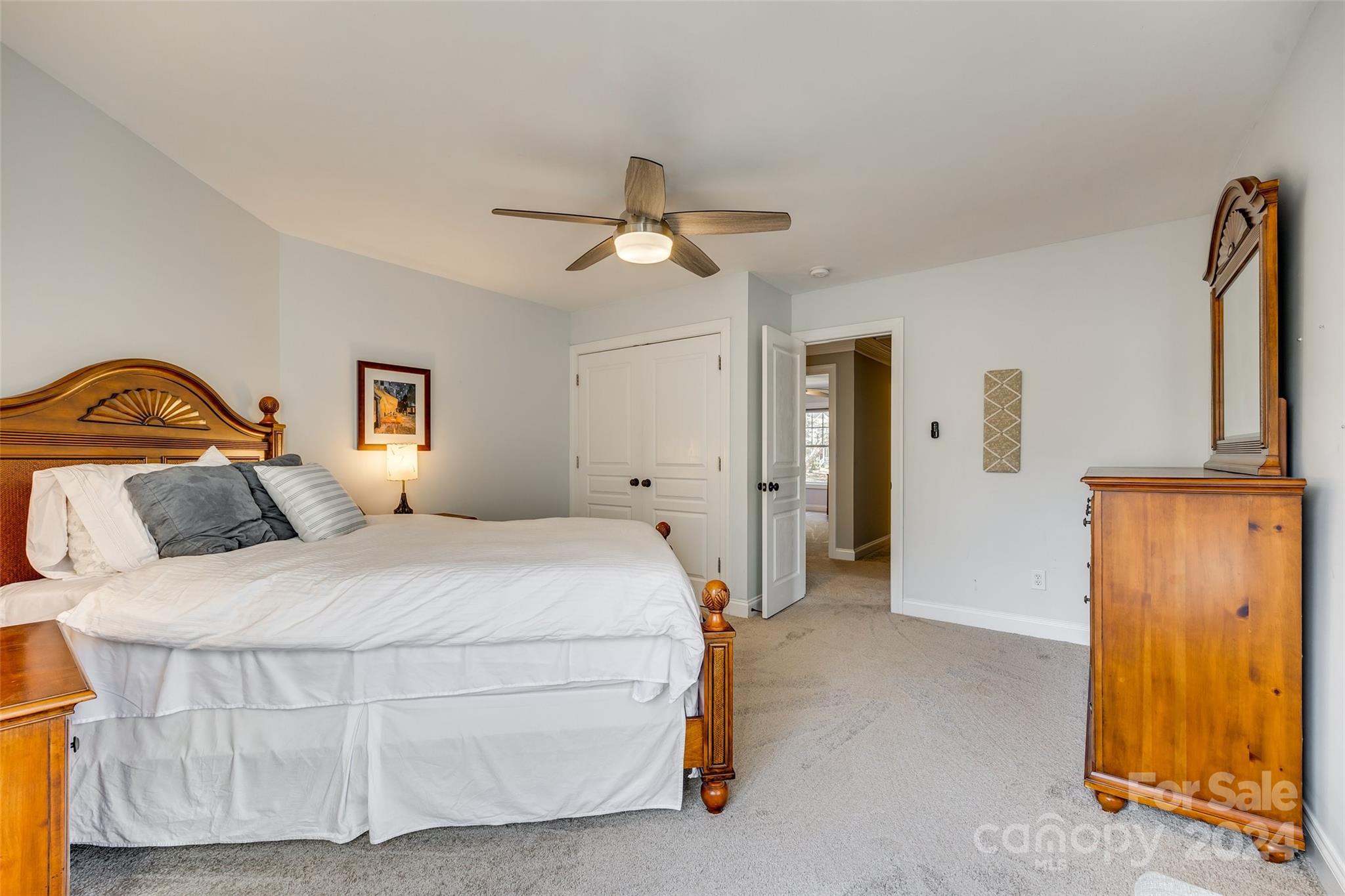 10621 Hanging Moss Trail Charlotte, NC 28227 - Photo 25 of 47 a bedroom with a bed and a chandelier