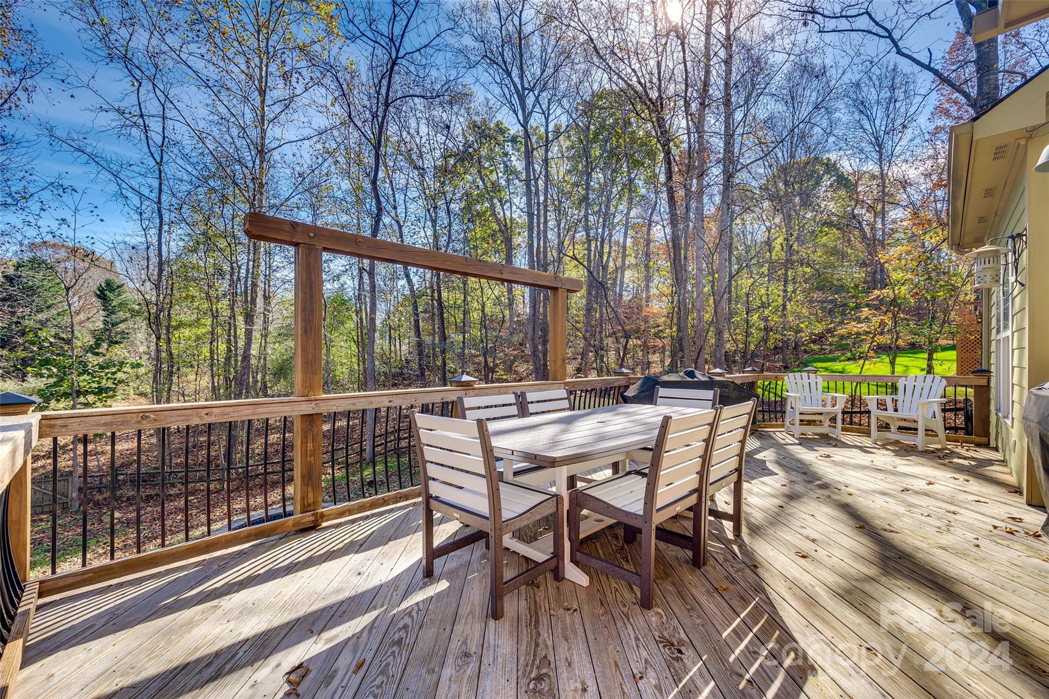 10621 Hanging Moss Trail Charlotte, NC 28227 - Photo 33 of 47 a view of a wooden deck with chairs and table in the patio
