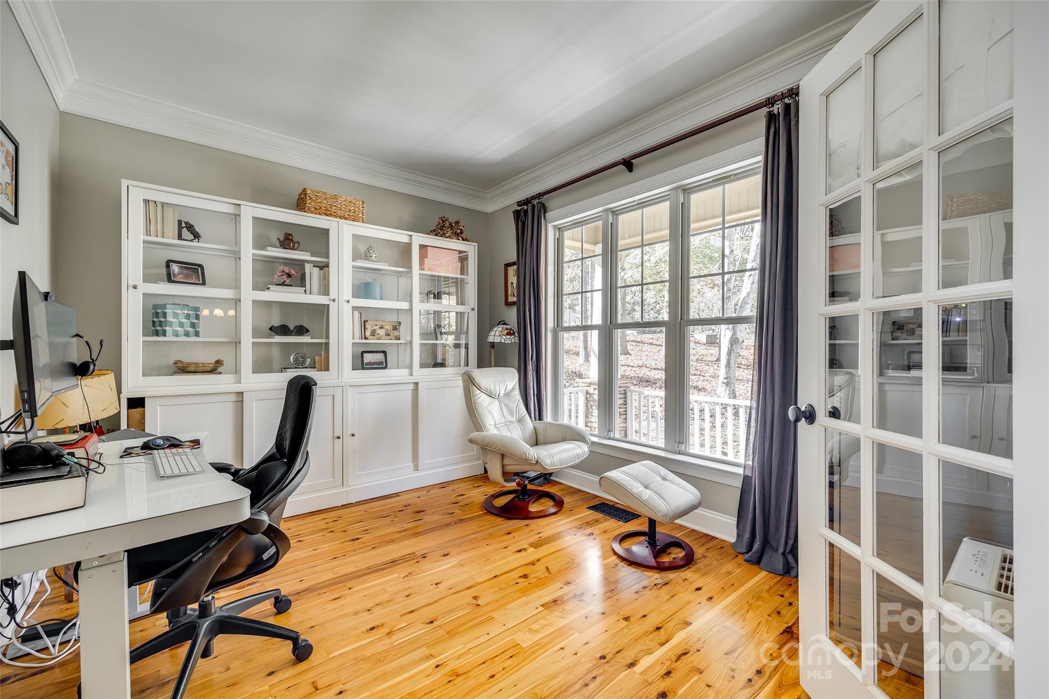 10621 Hanging Moss Trail Charlotte, NC 28227 - Photo 7 of 47 a view of a workspace with furniture and a window