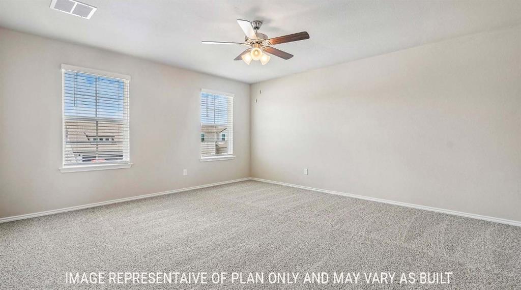 10101 Altair Drive Waco, TX 76708 - Photo 18 of 36 Neutral wall paint, textured carpet flooring, two windows with blinds, and a ceiling fan with integrated lighting