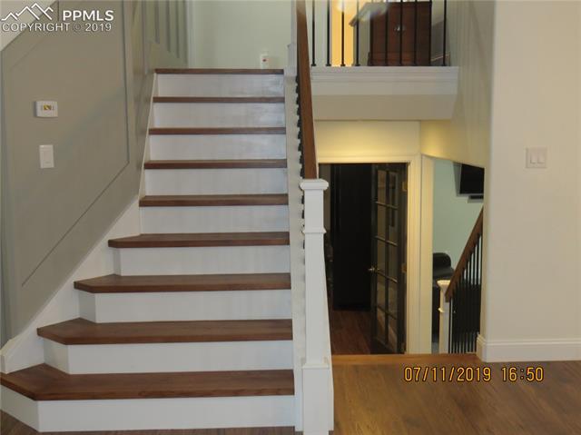 7799 Julynn Road Colorado Springs, CO 80919 - Photo 12 of 27 Beautiful hardwood stair cases.