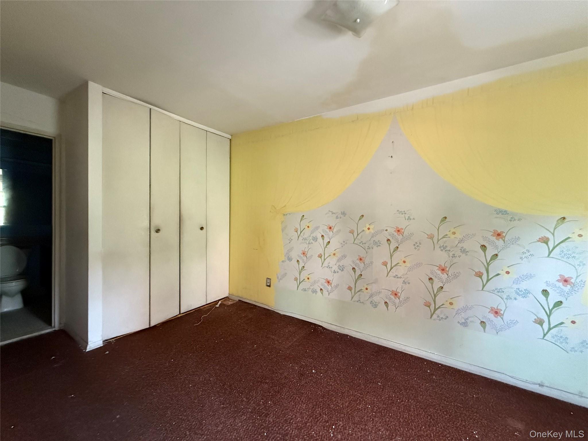 58-03 Calloway Street, Unit 3EE Queens, NY 11368 - Photo 13 of 20 Unfurnished bedroom featuring a closet and dark carpet
