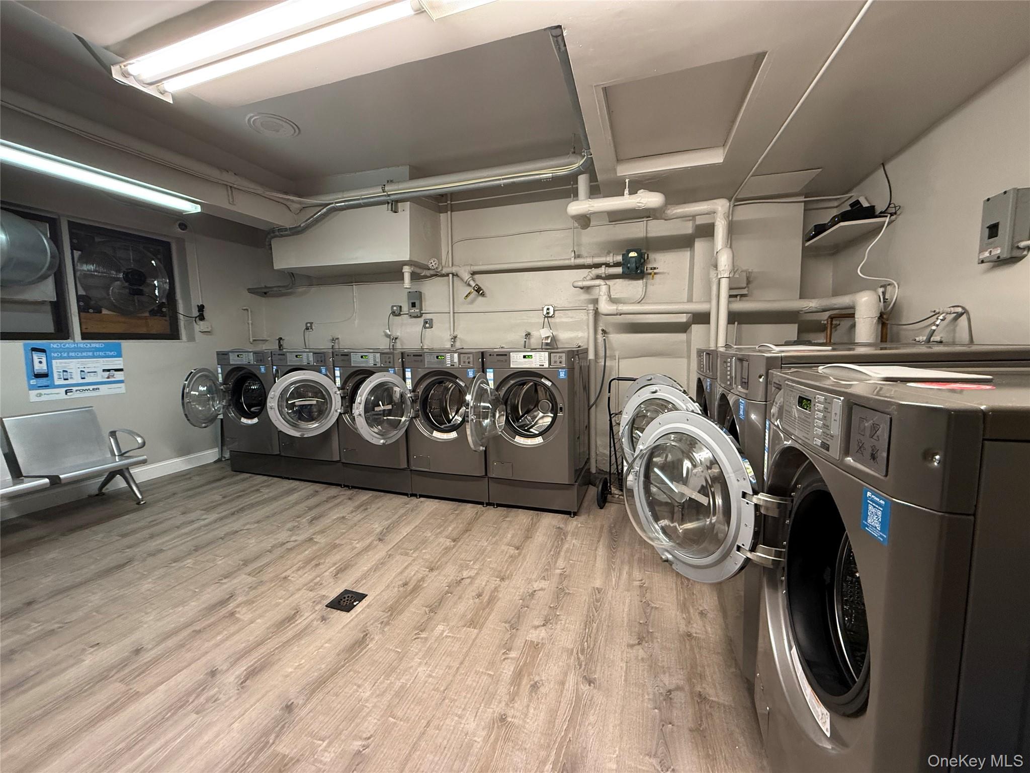 58-03 Calloway Street, Unit 3EE Queens, NY 11368 - Photo 17 of 20 Community laundry room with separate washer and dryer and light wood finished floors