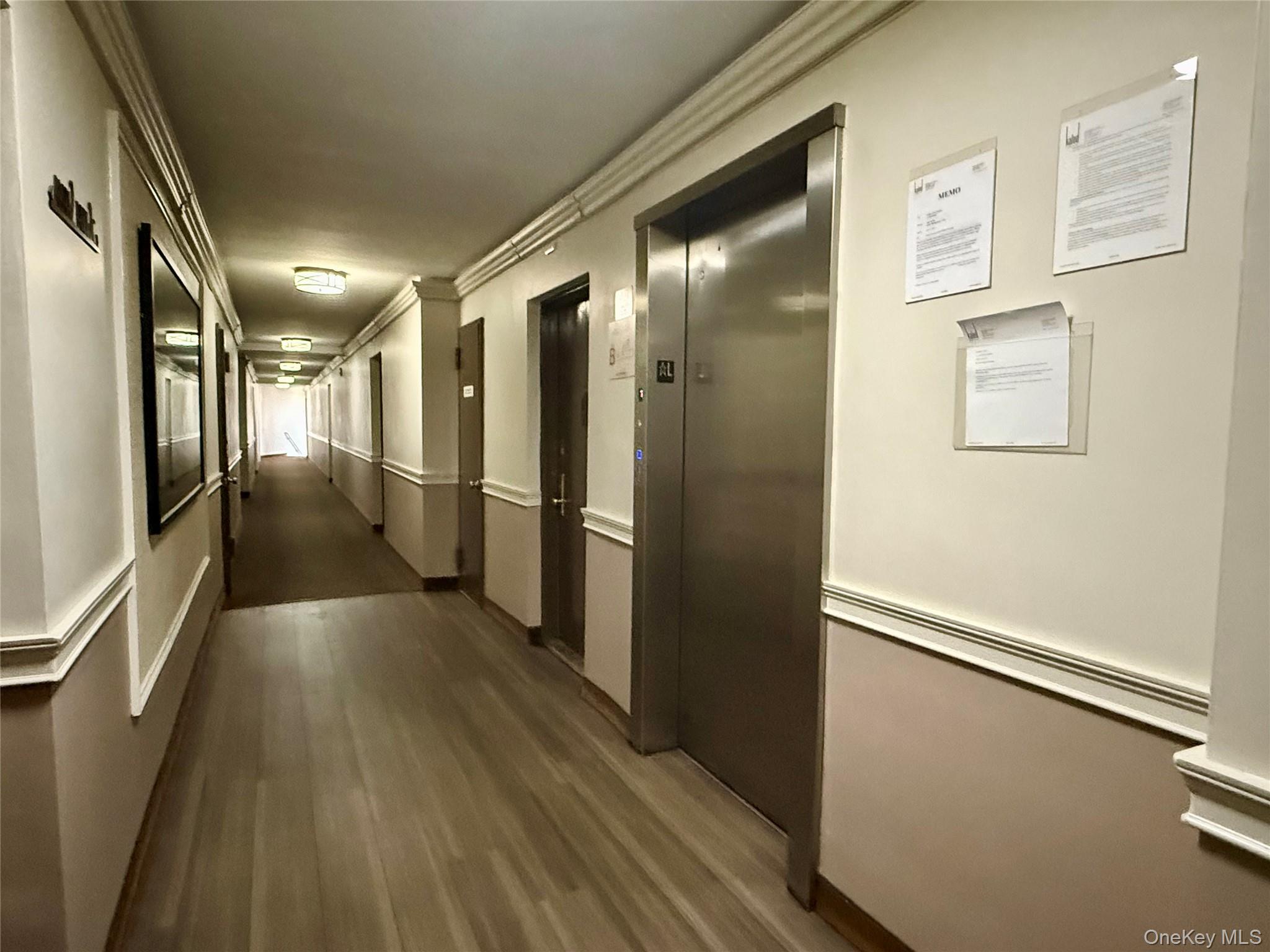 58-03 Calloway Street, Unit 3EE Queens, NY 11368 - Photo 9 of 20 Corridor featuring wood finished floors, elevator, and crown molding