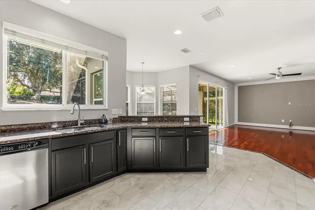 a large kitchen with stainless steel appliances granite countertop a sink and a stove