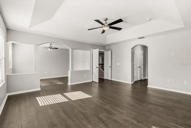 wooden floor in an empty room with a window