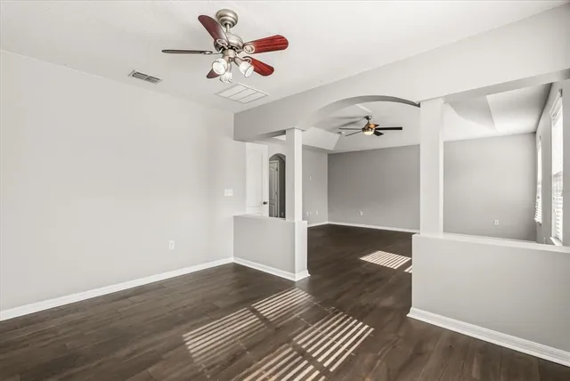 a view of a hallway with entryway and wooden floor