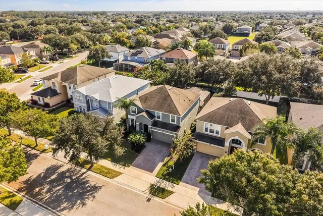 an aerial view of a house with a yard