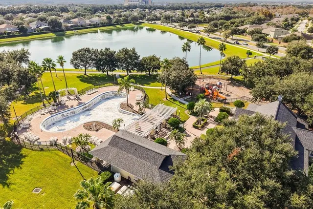 an aerial view of residential houses with outdoor space and swimming pool