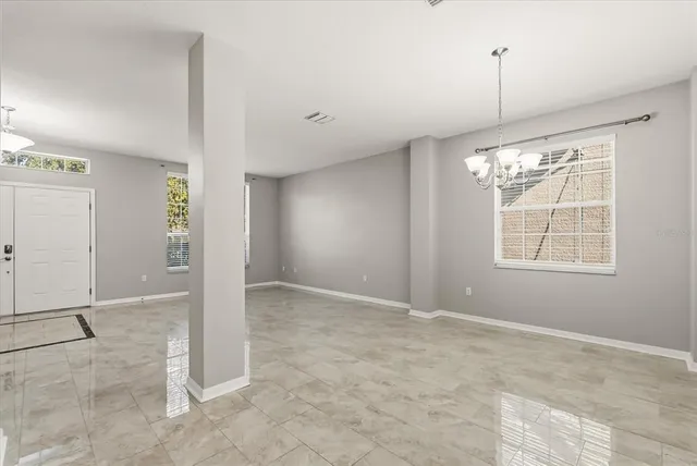 an empty room with windows and entrance