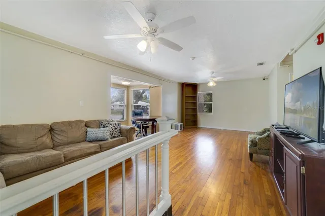 a living room with furniture ceiling fan and a rug