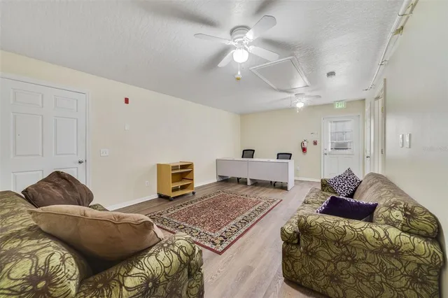 a living room with furniture and a chandelier