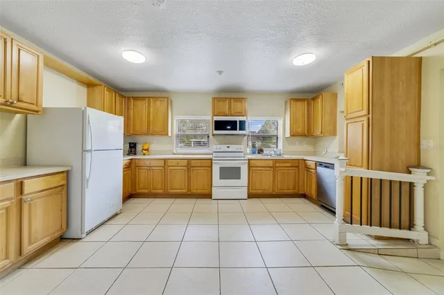 a view of a bathroom with sink mirror and window