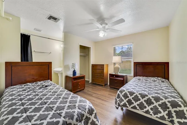 a bedroom with a large bed and a chandelier
