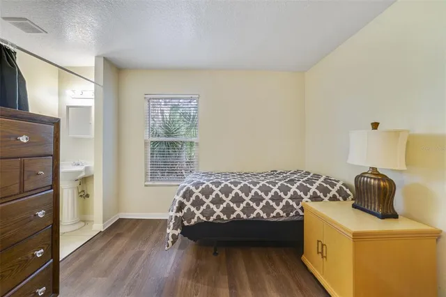 a bedroom with a bed and a dresser