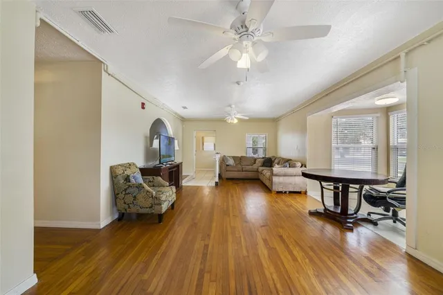 a living room with furniture and a chandelier