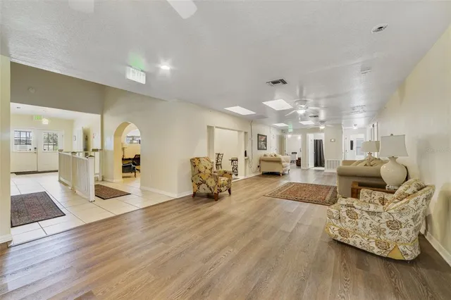 a living room with furniture and a chandelier
