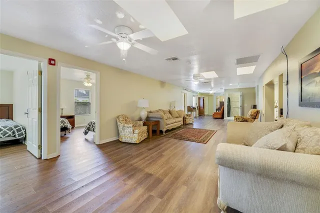 a living room with furniture and a wooden floor