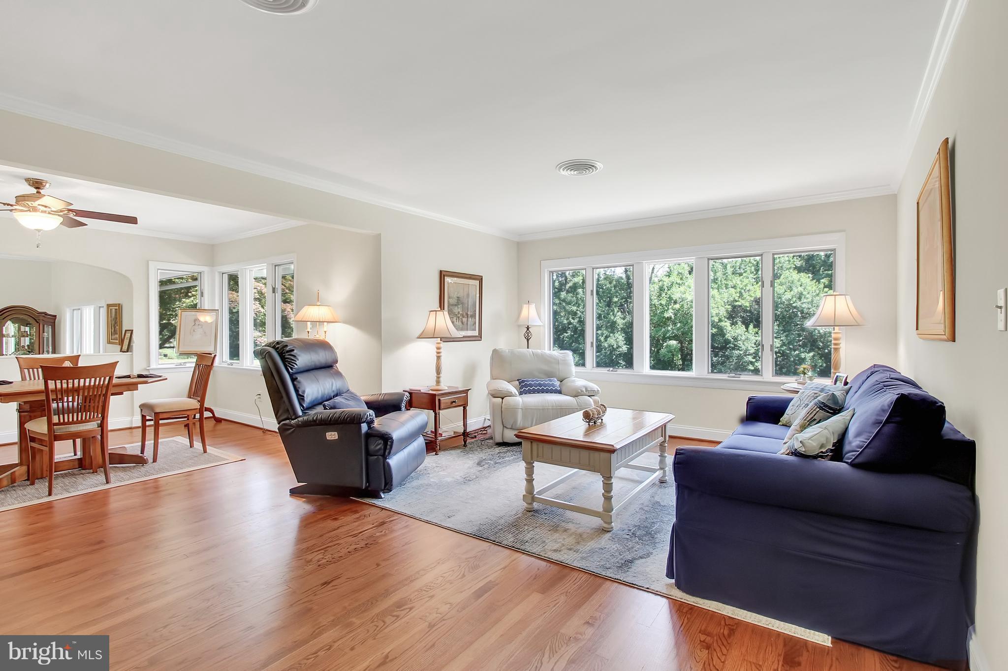 13400 Blythenia Road Phoenix, MD 21131 - Photo 4 of 25 a living room with furniture floor to ceiling window and wooden floor