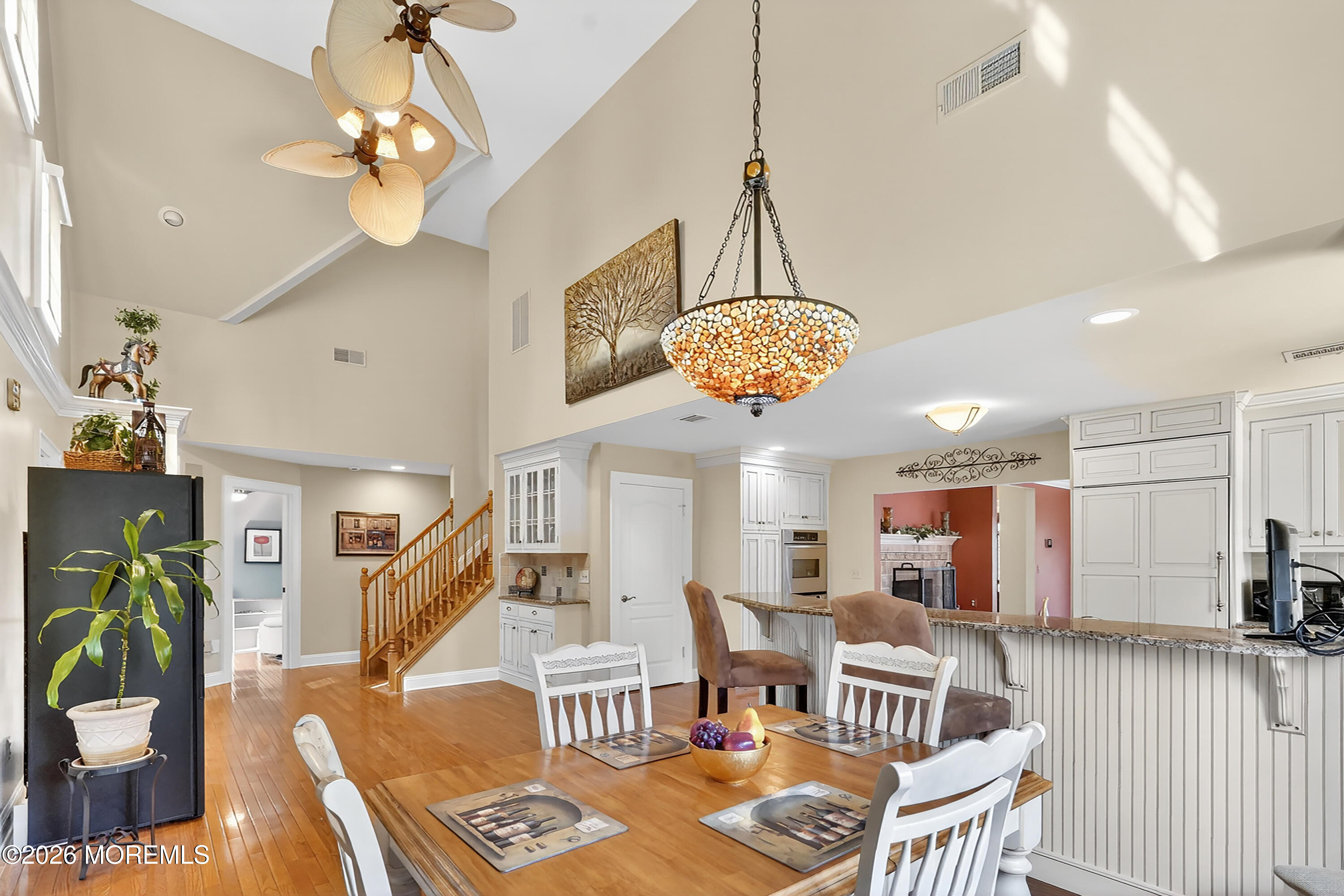 617 Oceanview Road Brielle, NJ 08730 - Photo 20 of 94 a view of a dining room and livingroom with furniture wooden floor a chandelier