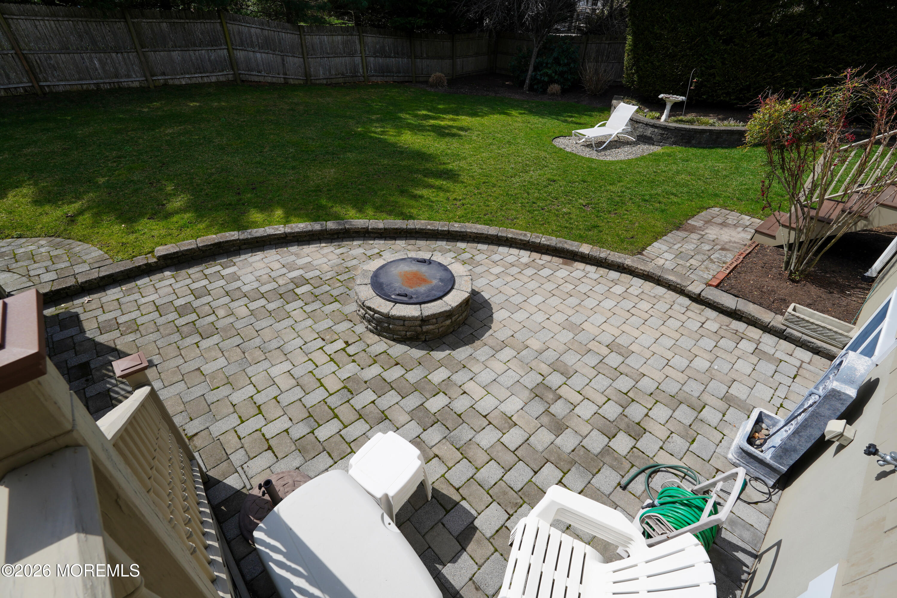 617 Oceanview Road Brielle, NJ 08730 - Photo 67 of 94 a view of a backyard with table and chairs potted plants and wooden fence