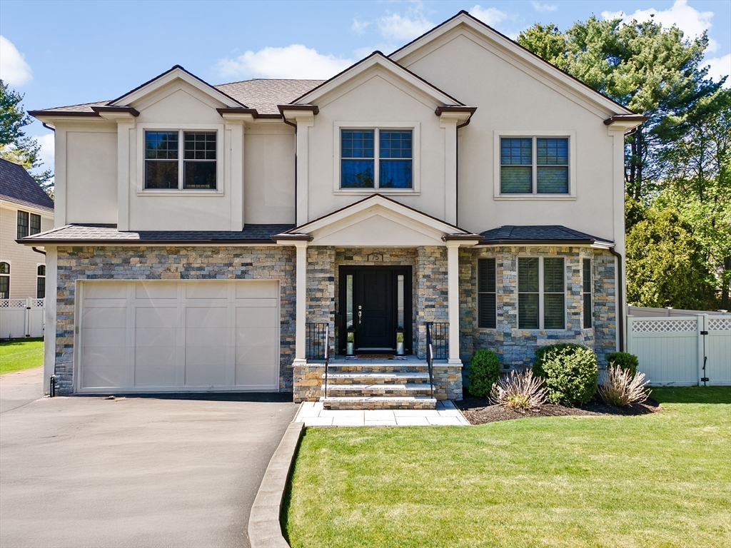 a front view of a house with a yard and garage