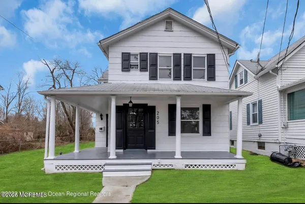 a front view of a house with a yard table and chairs