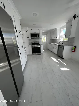 a view of a kitchen with microwave and cabinets