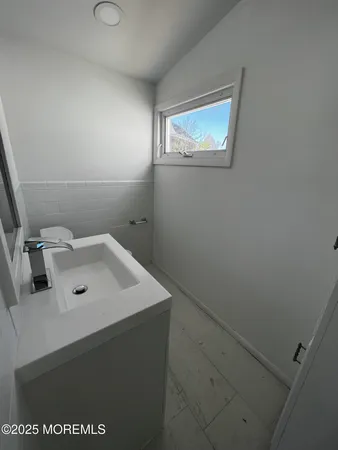a bathroom with a sink mirror and vanity