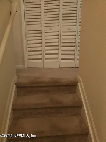 a metallic refrigerator freezer sitting in a kitchen