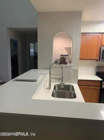 a kitchen with a stove microwave and sink