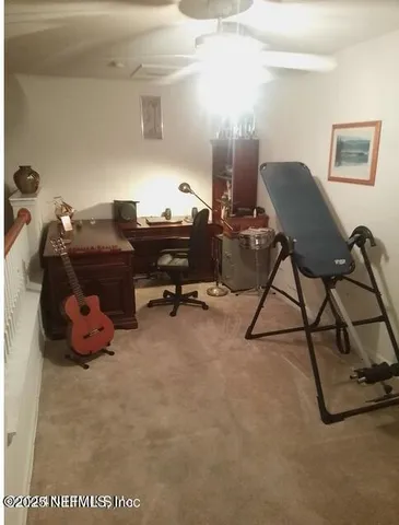 a view of a room with gym equipment and a large window