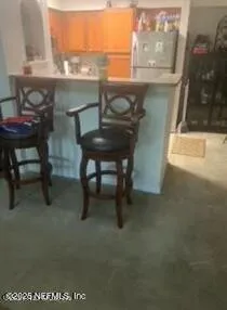 a view of a room with a table and chairs