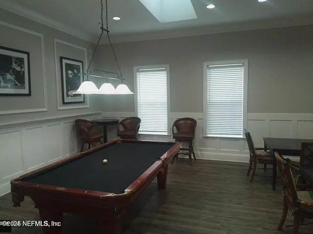 a dining room with furniture and a flat screen tv