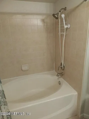 a bedroom with a bed and mirror