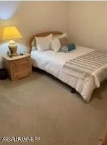 a bedroom with a bed and a lamp on table