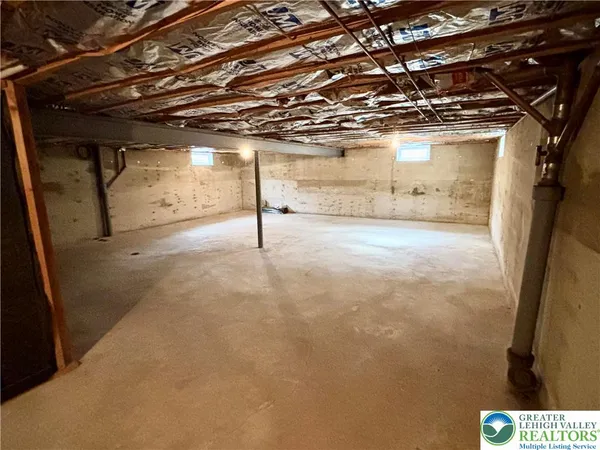 a view of empty room with wooden walls