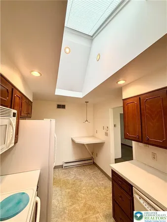 a living room with a sink and a stove top oven