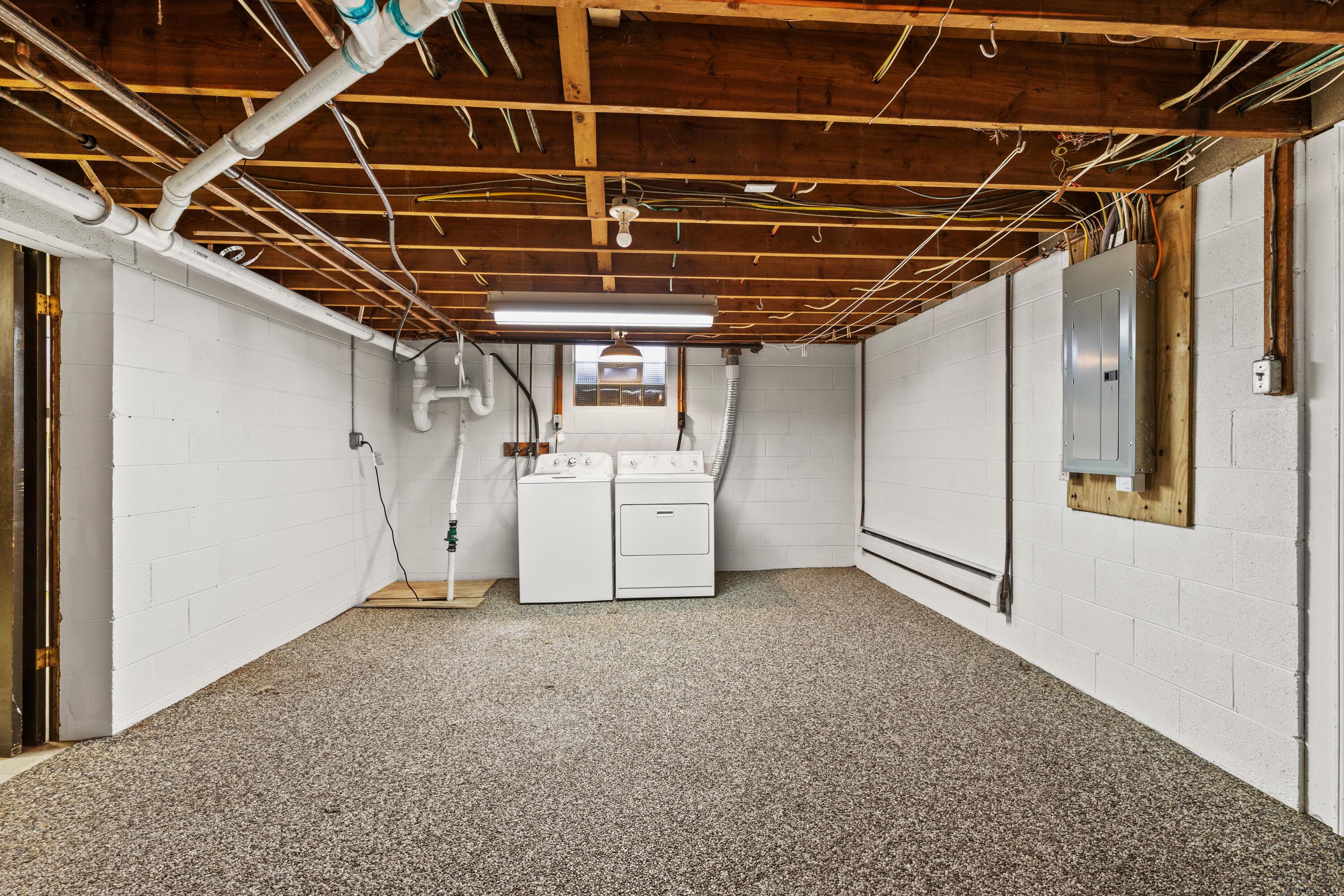 6982 Lee Road Westerville, OH 43081 - Photo 58 of 71 • New epoxy flooring ~ 2018/2020 • New sump pump ~ 2025 • Glass block windows • Electric dryer hookup • Walks-up to rear yard with Bilco® steel doors • New sewer piping ~ 2024 • Baseboard heat • AO Smith® pressure tank • AO Smith® water softener (owned) • AO Smith® gas water heater • Sears® natural gas boiler • Laundry chute outlet • New sewer piping ~ 2024