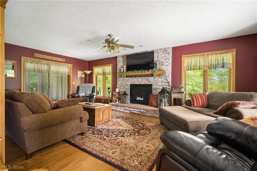 314 Three Bridges Road Palestine, WV 26160 - Photo 15 of 35 Living room, hardwood floors and statement stoned fireplace