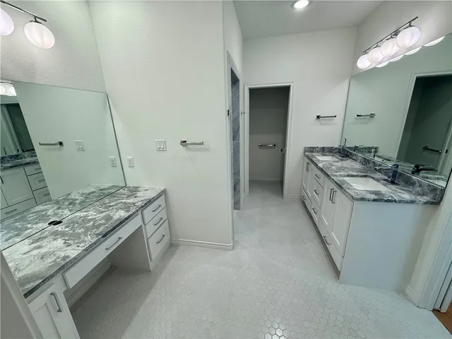 a view of a kitchen with a sink and a large window