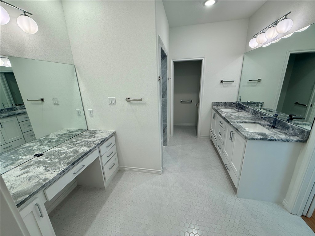 3533 Leesburg Path Bryan, TX 77808 - Photo 8 of 28 a bathroom with a granite countertop sink a toilet and a mirror